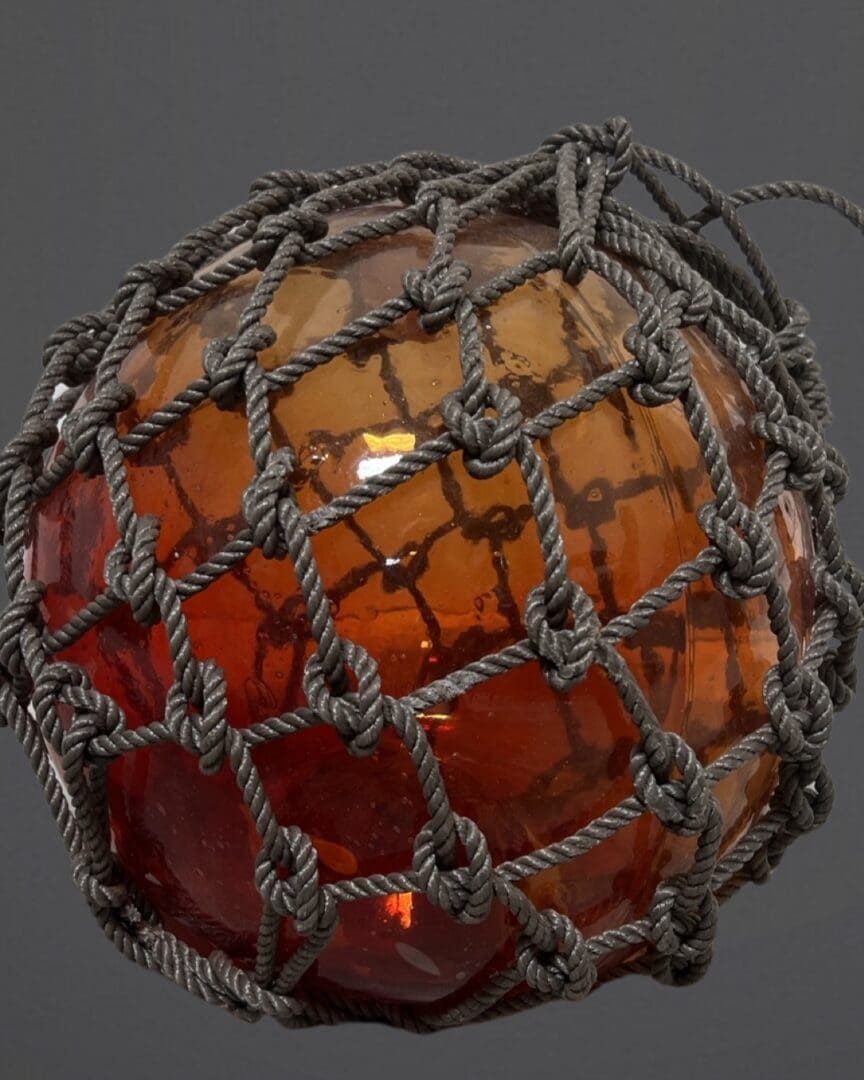 A glass ball with a net around it.