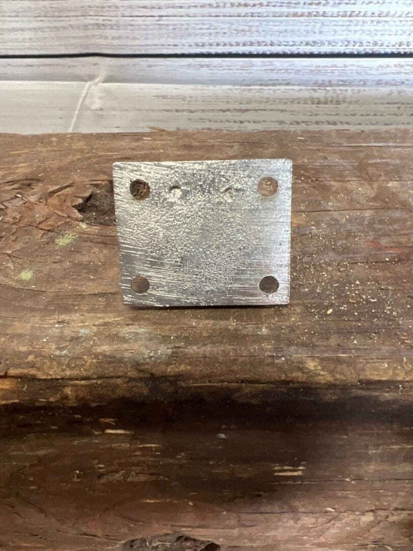A metal plate sitting on top of a wooden table.
