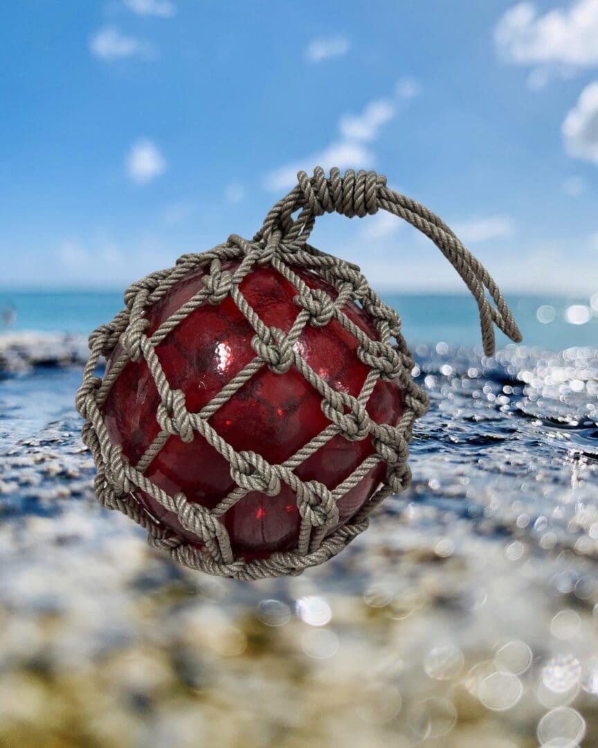 A red ball with a string attached to it.