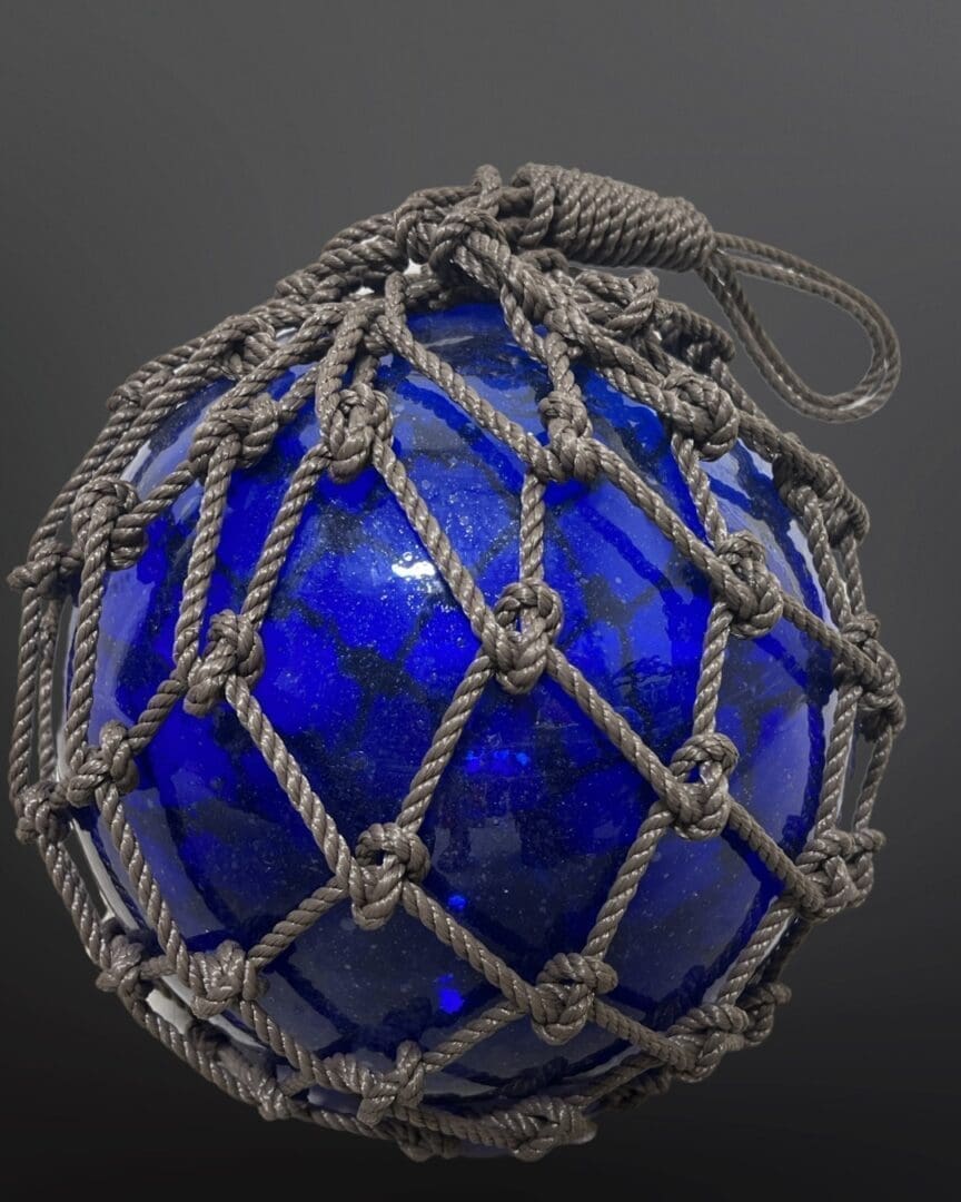 A blue glass ball with rope around it.