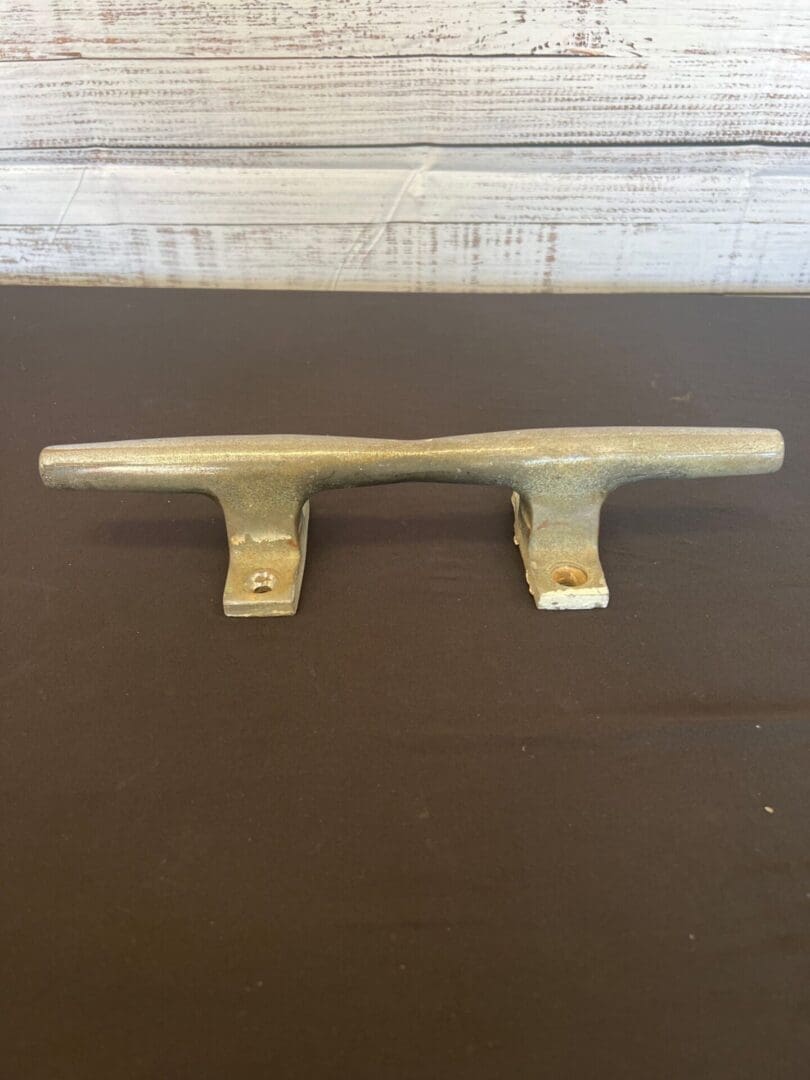 A metal handle sitting on top of a table.