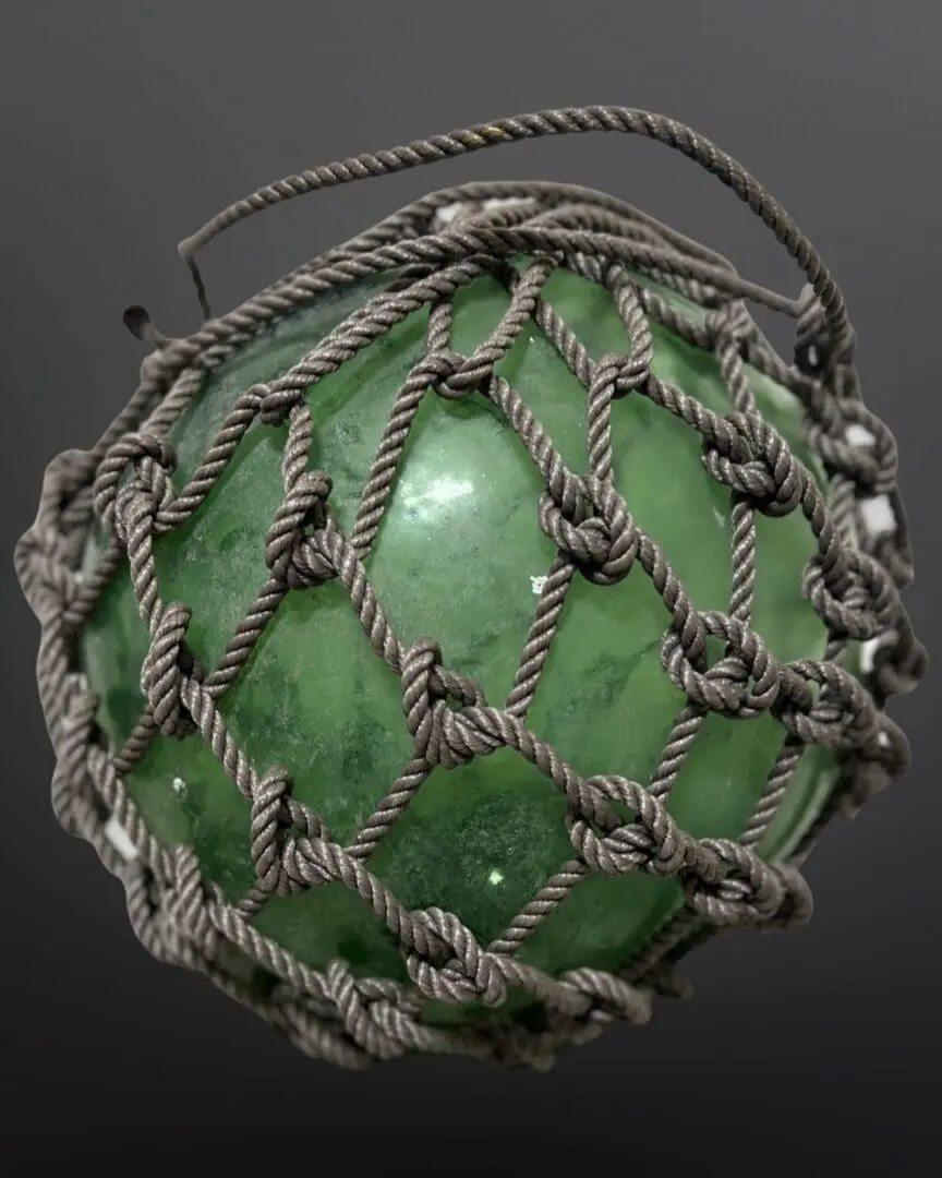 A green ball with rope around it.