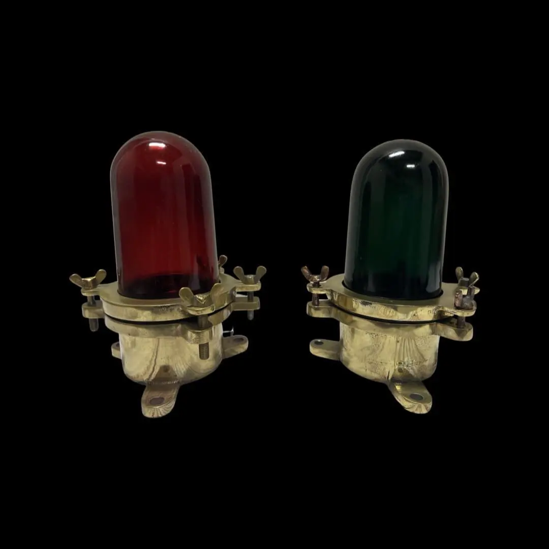 Two red and green lights are sitting on a black background.