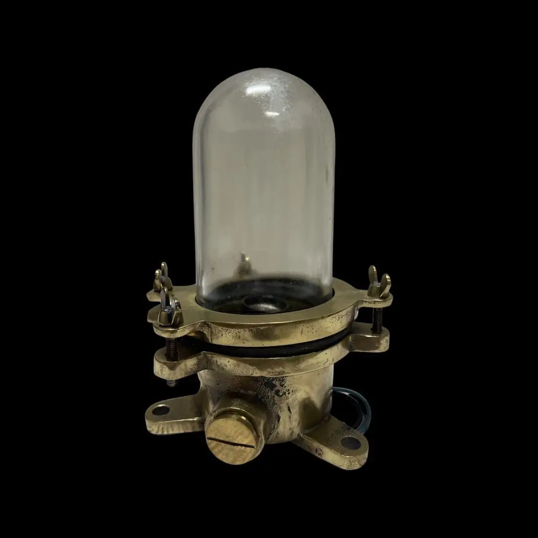 A close up of an old lamp with a glass dome