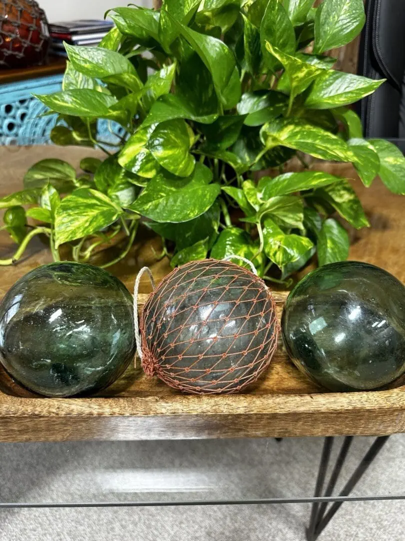 Three glass balls are sitting on a table.