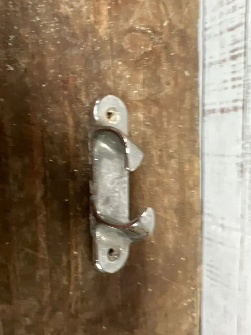 A metal handle on the side of a door.
