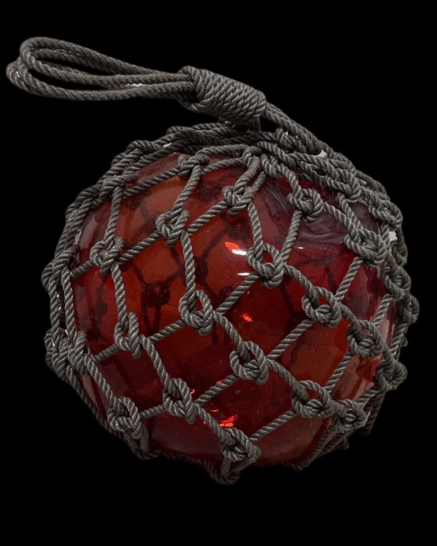 A red ball with a string around it.