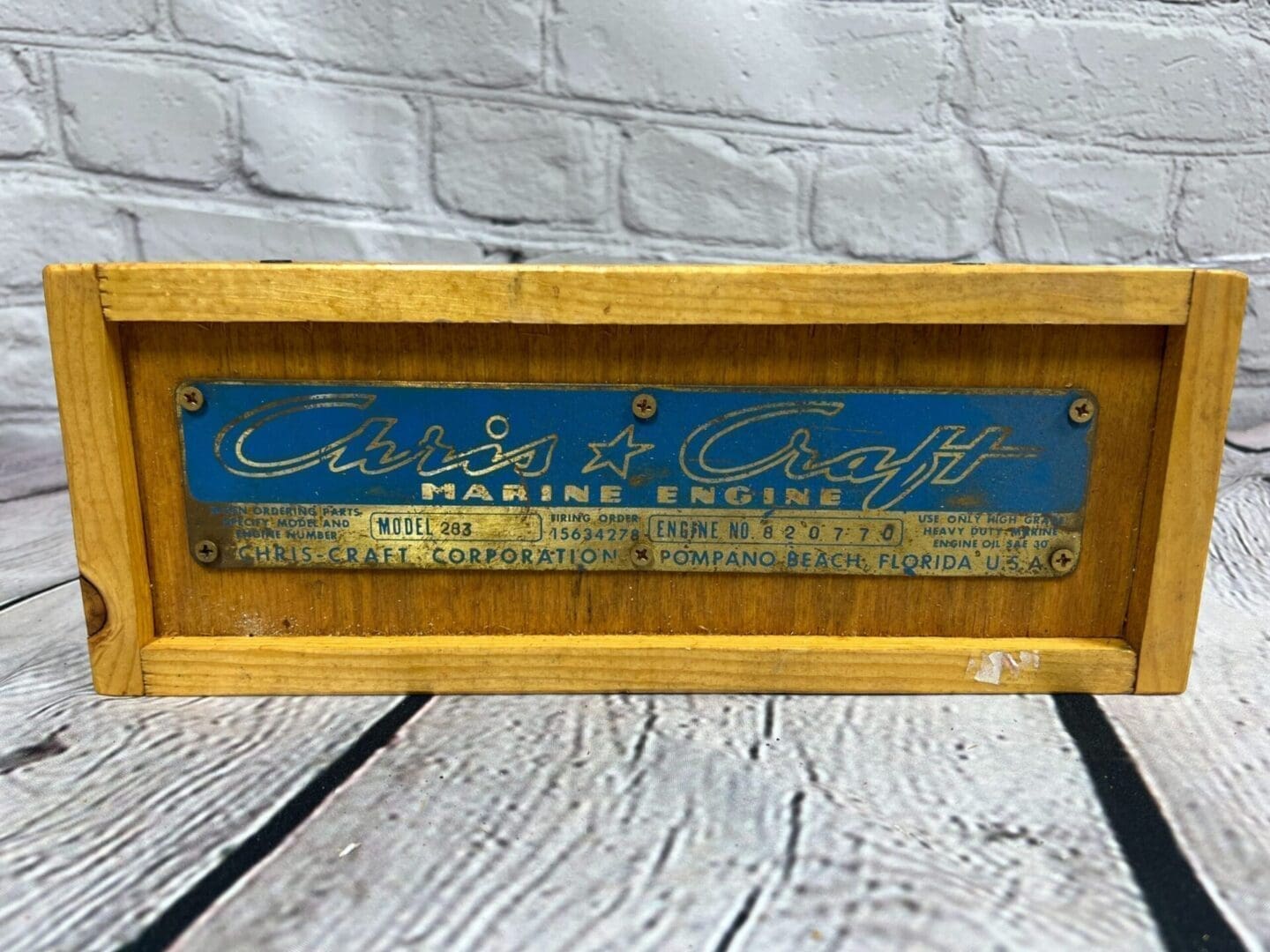 A wooden box with the name of an old boat.