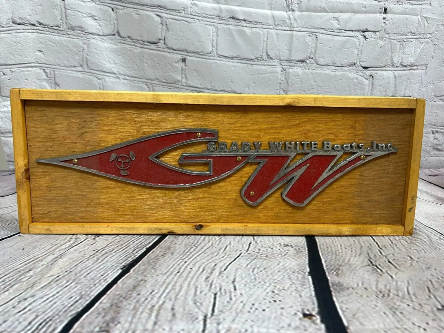 A wooden box with the logo of the company gw.