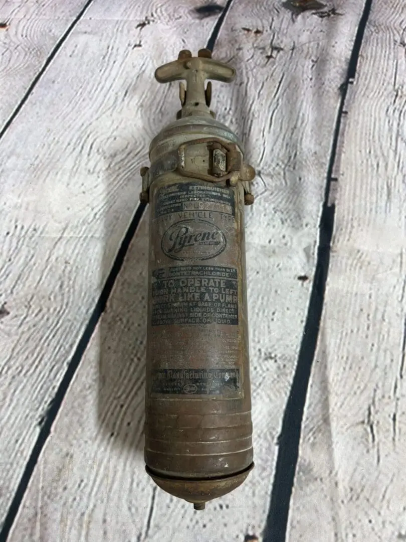 A fire extinguisher sitting on top of a wooden floor.