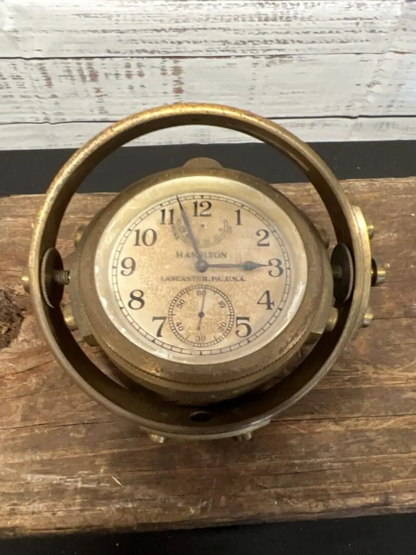 A clock that is sitting in the middle of a table.