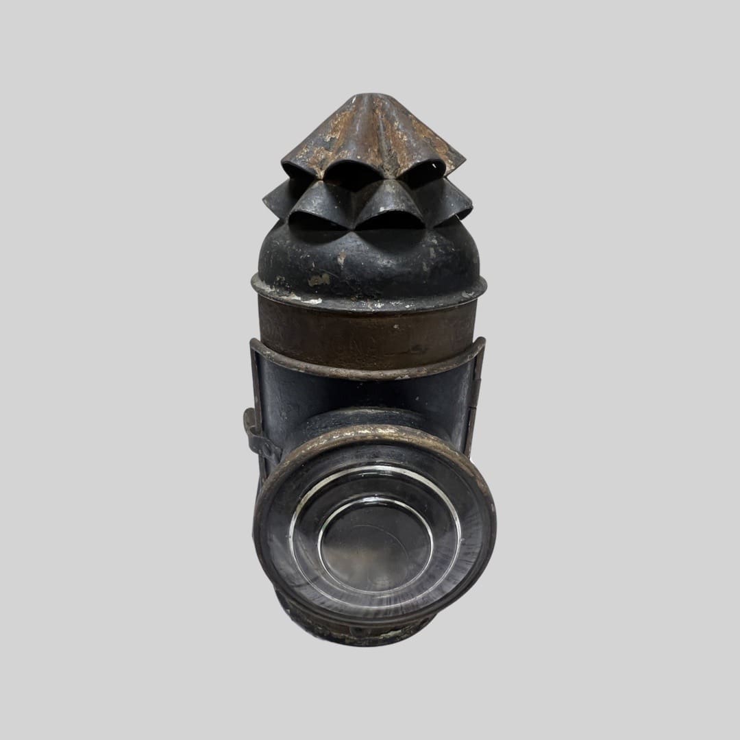 A metal object with a pointed top and cone shaped head.