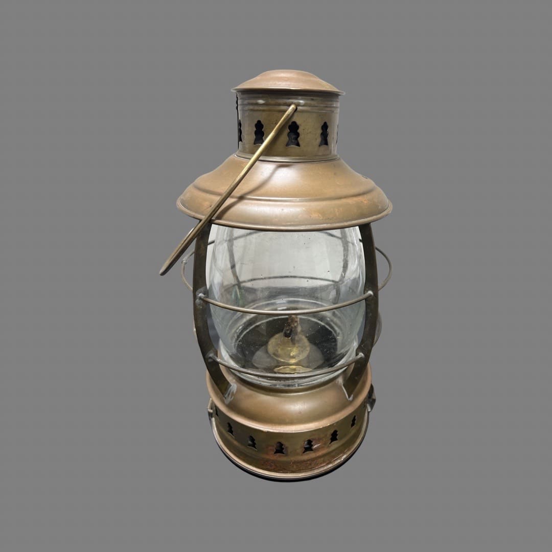 A lantern with a glass bowl inside of it.