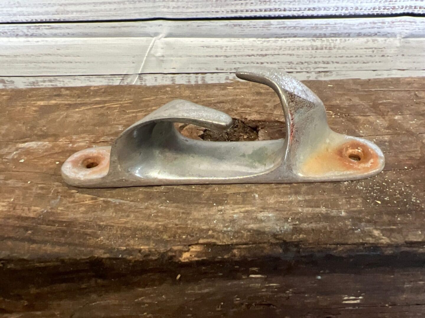 A metal object sitting on top of a wooden table.