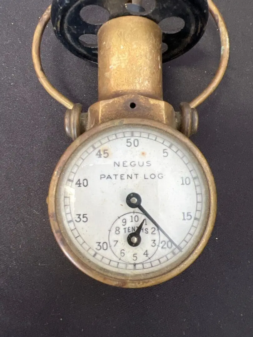A close up of an old time pressure gauge