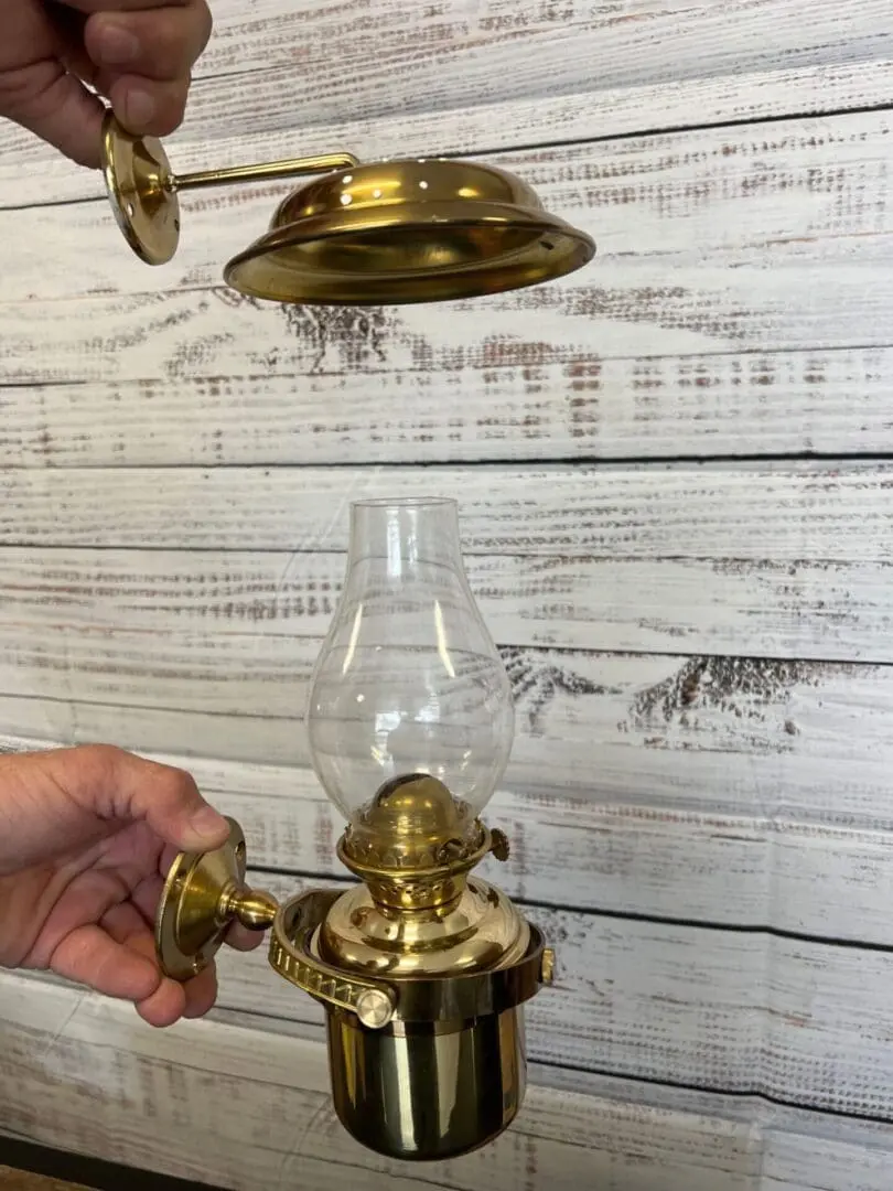A person is holding onto the oil lamp