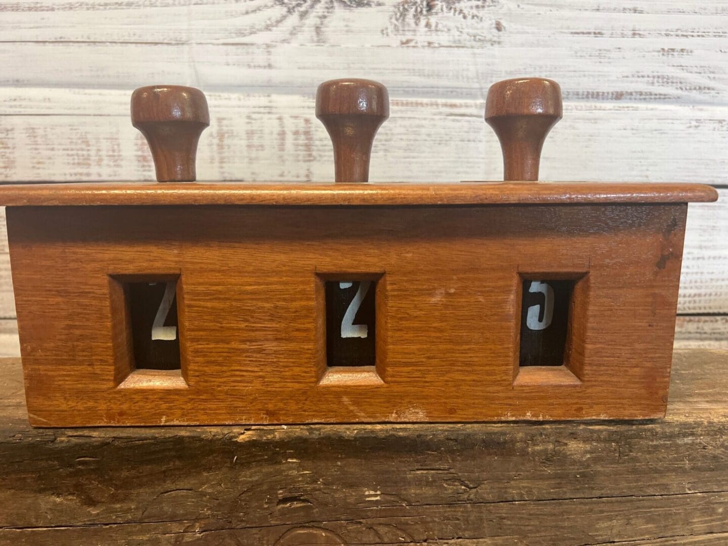 A wooden box with numbers on it