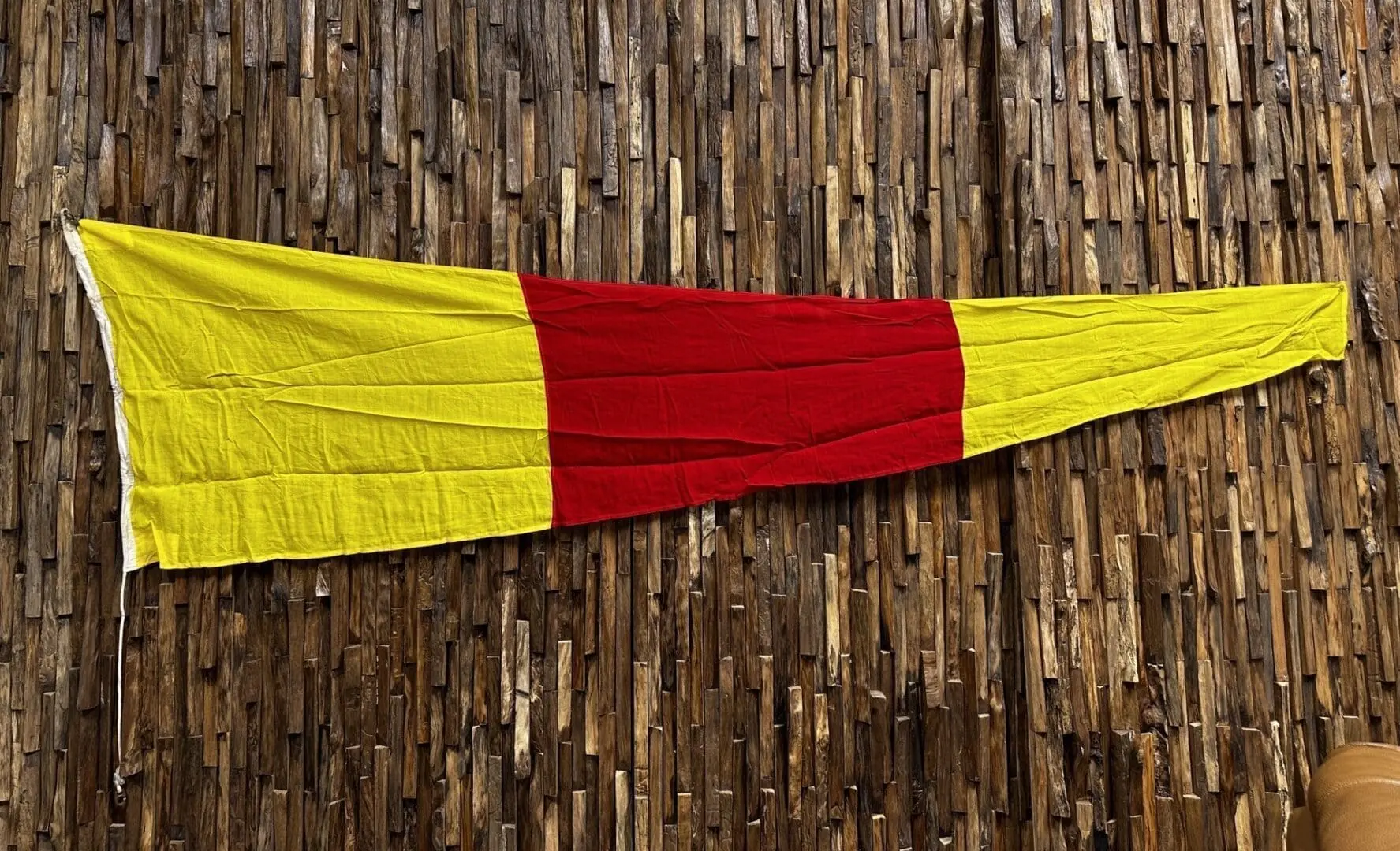 A red and yellow flag hanging on the wall.