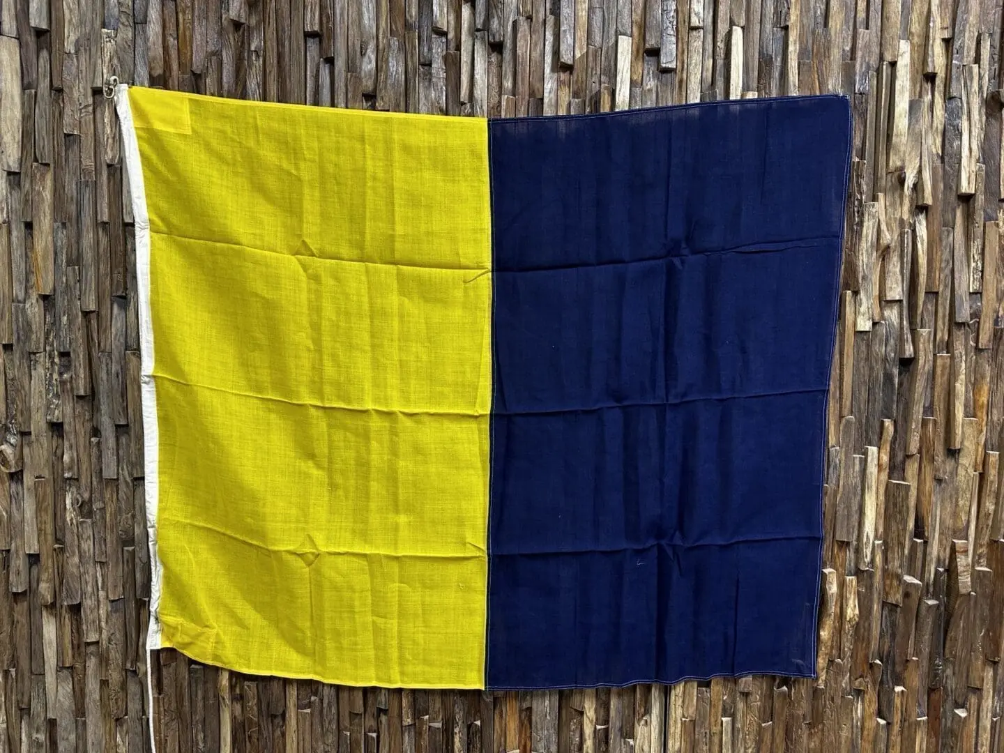 A yellow and blue flag hanging on the wall.