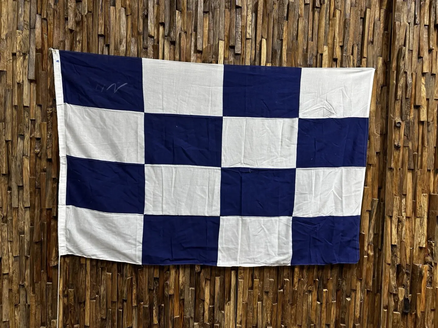 A blue and white checkered flag hanging on the wall.