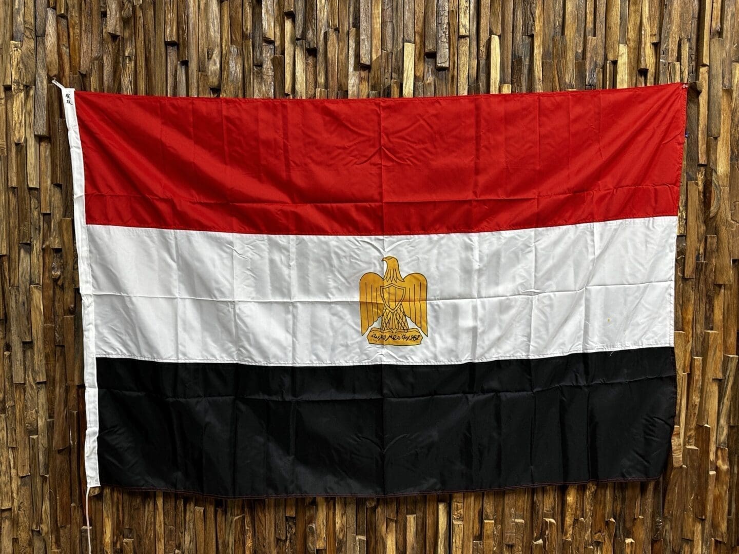 A flag of egypt hanging on the wall.