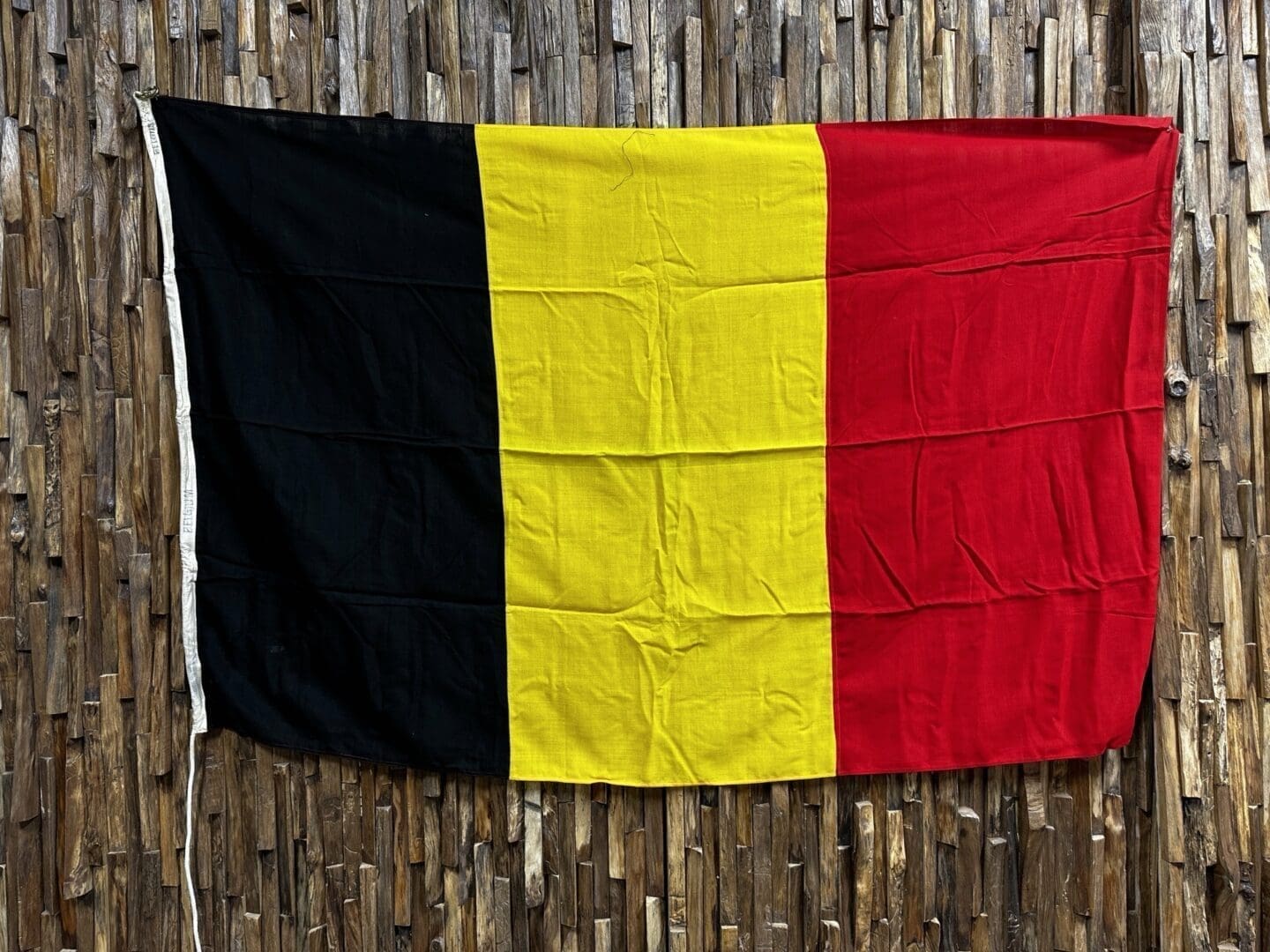 A flag of belgium hanging on the wall.