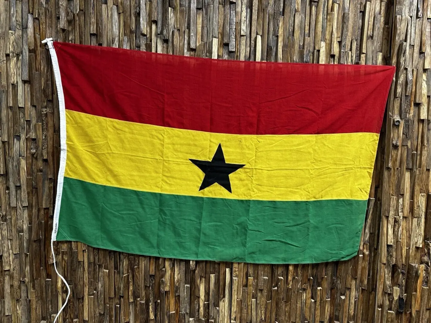 A flag of ghana hanging on the wall.