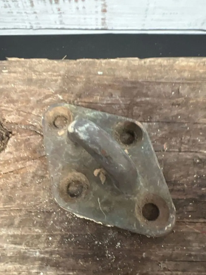 A metal object sitting on top of a wooden table.