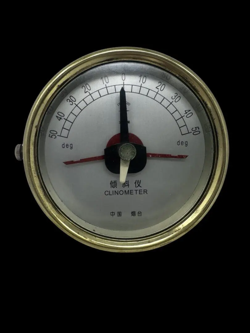 A close up of the clinometer on a black background