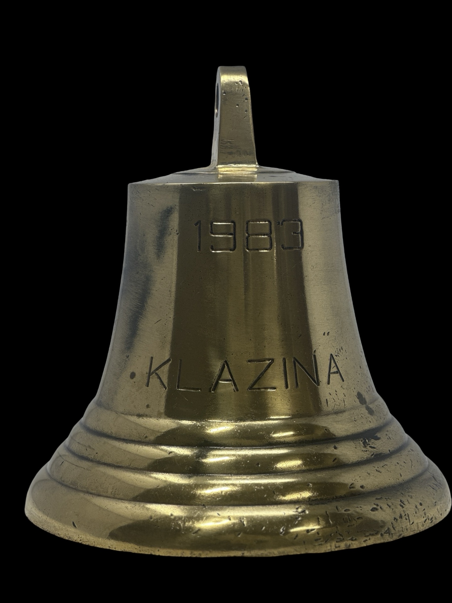 Brass bell with "1983 KLAZNA" inscription.