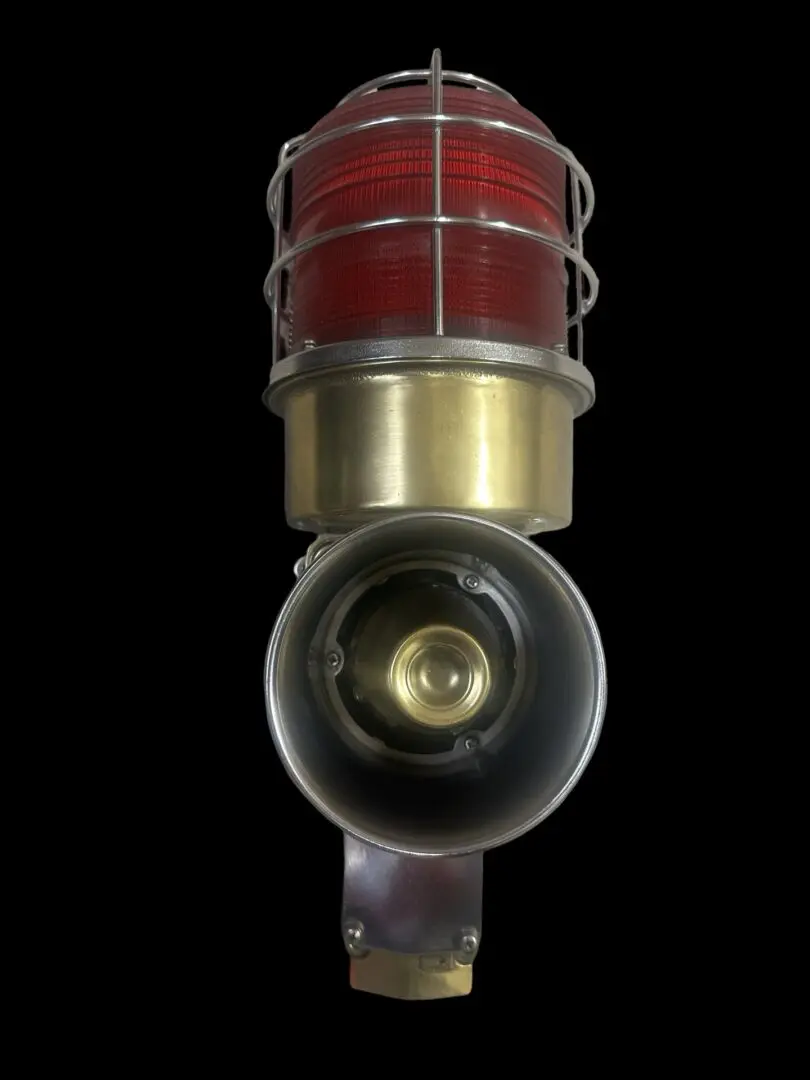 Red and brass warning light with a cage.