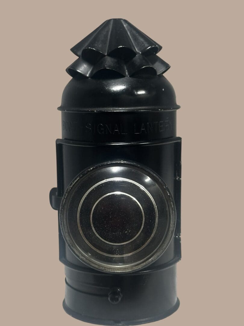 Black railway signal lantern with lens.