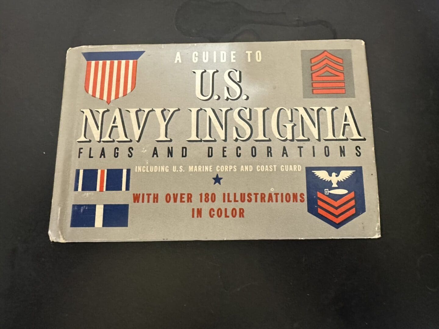 Cover of a guidebook to U.S. Navy insignia, flags, and decorations.